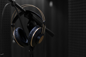 microphone and headphones on a black background