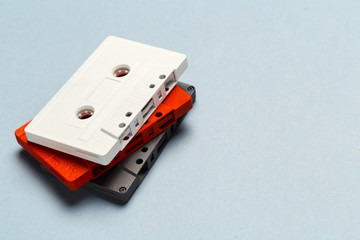 Bright retro cassette tapes on a light grey background
