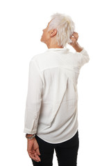 Rear view of older woman scratching her head, isolated on white.