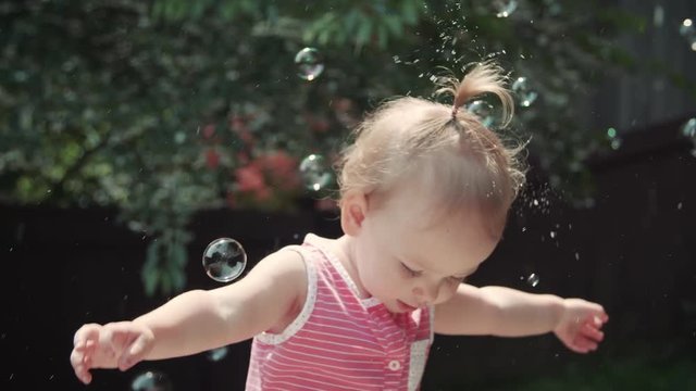 Baby Girl Dancing Outside in Bubbles