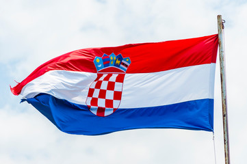 Emotional waving Croatian flag on rusty flagpole