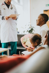 Doctor giving good news to relatives in the waiting room