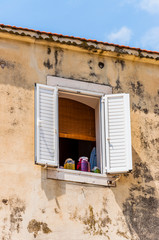 Fototapeta na wymiar Canning in glass jars on old medieval building facade window