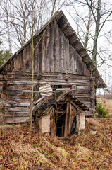 Abandoned triangle canopy entrance to rural wooden house basement