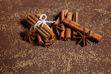 Baking ingredients Cinnamon sticks, star anise and cane brown sugar. Winter Christmas spices macro.