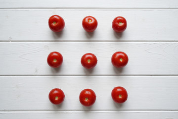 top view of cherry tomato flat lay on white wooden background