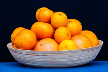 Plate with orange citruses fruits. Oranges, mandarines and tangerines