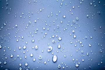 Drops of water on a color background. Blue. Toned