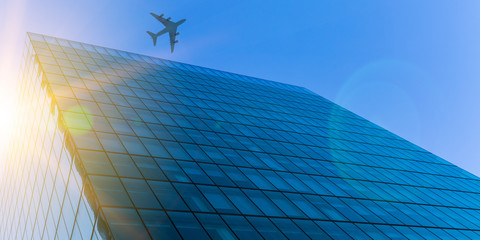 Airplane above business city