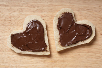 two heart shaped bread slices with chocolate spread for Valentine's day 