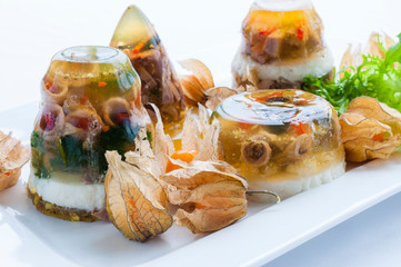 Decorated food. Aspic cold dish with meat, jelly, vegetables, greenery.
