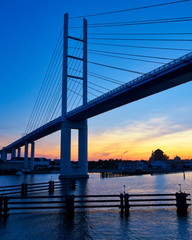Fototapeta na wymiar Bridge to the island Rügen with sunset and blue sky. Germany