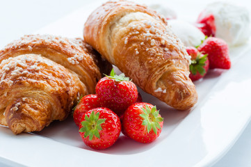 Decorated food. Croissants with strawberries and ice cream dessert