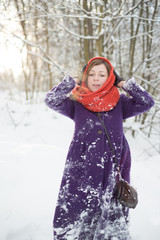 Woman walking in the winter forest