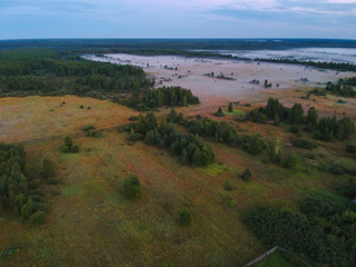 Fog at sunset over the surroundings of the village from a height