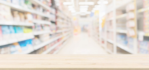 Wood table top with supermarket aisle blur background for product display