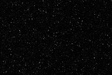 Falling snow on black background. Winter background in pure dark. Heavy snow.