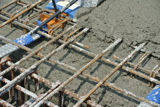 The wet concrete is poured on a steel reinforcement bar to form strong floor slabs called Reinforce Concrete Slab. 
