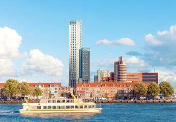 Rotterdam skyline view with tourist boat in bay and modern office buildings in the background