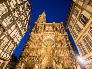 Strasbourg Cathedral illuminated at night (Cathedral of Our Lady of Strasbourg or Cathedrale Notre-Dame de Strasbourg), also known as Strasbourg Minster, Alsace, France wide angle - obrazy, fototapety, plakaty