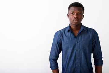 Portrait of young black African man against white background