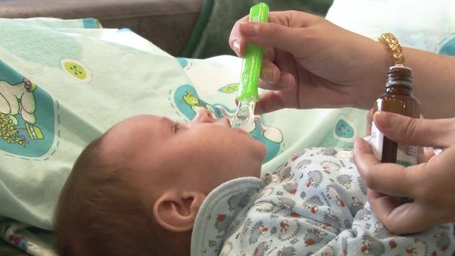The child is given medicine. Crying baby