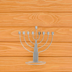 top view of menorah on wooden surface, hannukah holiday concept