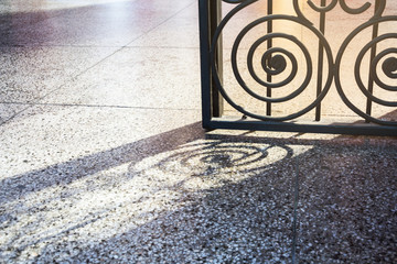 Detail of iron door. shadows on the floor