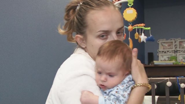 Mom soothes a child who has a stomach ache