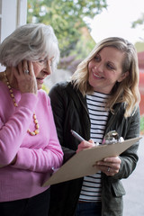 Female Sales Person Trying To Persuade Senior Woman To Purchase Goods Or Services