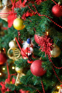 Close-up of a branch of a Christmas tree with bright toys.