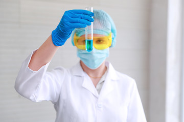 Fototapeta na wymiar scientist woman with equipment and laboratory glassware holding chemical liquid and checking result using as science research background