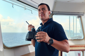 Portrait of navigator / pilot / officer on the bridge of the vessel