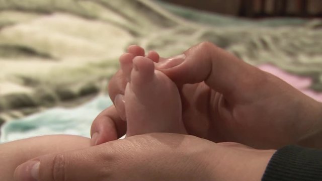 Baby knead leg with a massage