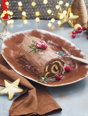 Chocolate yule log Christmas cake with  raspberries.
