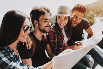 Group of Young Smiling People Holding Paper Map