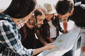 Group of Young Smiling People Holding Paper Map