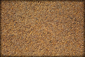 Small yellow stones on the road surface as background