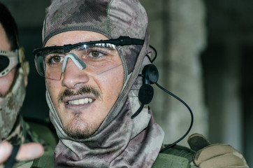 Obraz premium Airsoft soldier with trasmiter microphone communication, full faces mask gloves