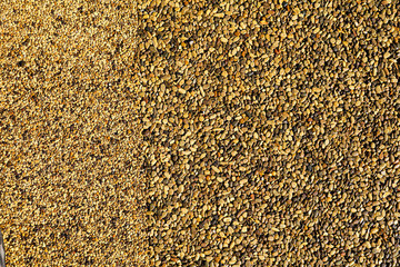 Small yellow stones on the road surface as background