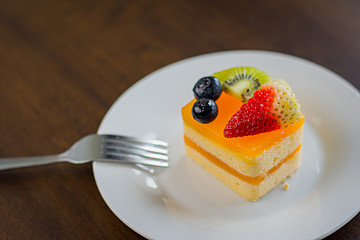Orange cake is placed in a delightful white dish