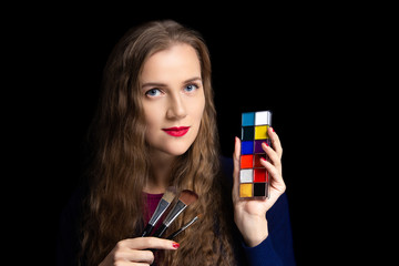 Young beautiful girl holding make up palette