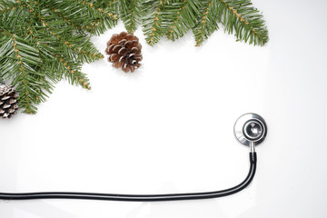 Celebrating Christmas in the healthcare industry. Top view of flat lay. Stethoscope with ornaments...