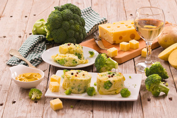 Potato gratins with broccoli florets.
