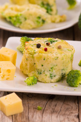 Potato gratins with broccoli florets.