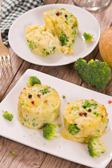Potato gratins with broccoli florets.