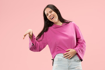 Happy business woman standing and smiling isolated on pink studio background. Beautiful female half-length portrait. Young emotional woman. The human emotions, facial expression concept