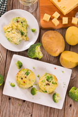 Potato gratins with broccoli florets.