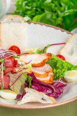 Fresh salad with chicken breast, arugula and tomato. Top view