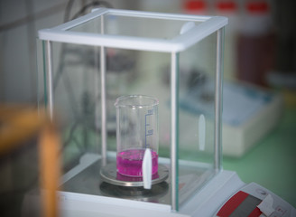 Chemical laboratory. Weighting liquid in the flask